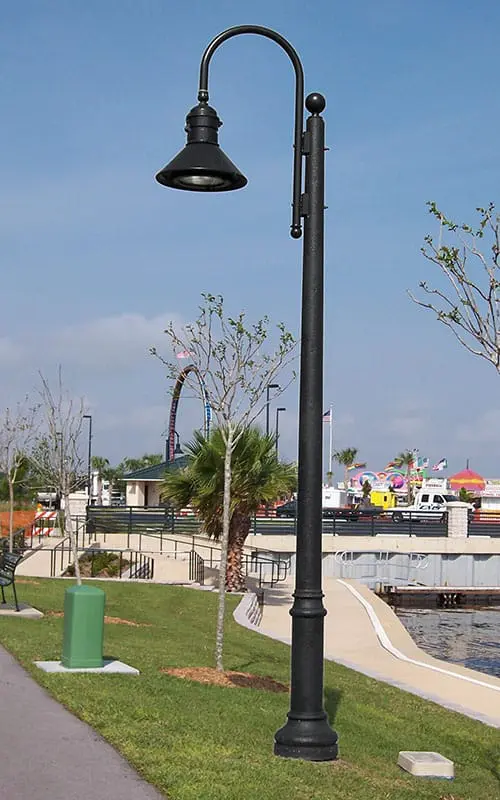 A K828 Moderne Sr. fixture accompanied by a Bishop Crook style arm on top of a Canterbury pole.