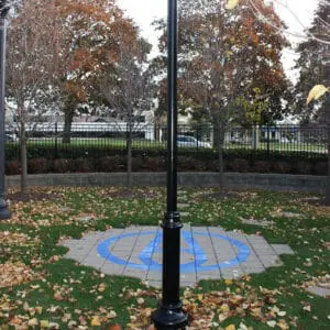 KAS1- Agility Pole - Burlington, Ontario A black aluminum pole with a round non-tapered cross section accompanied by a decorative base plate. This project is in Burlington, Ontario at StressCrete's headquarters.