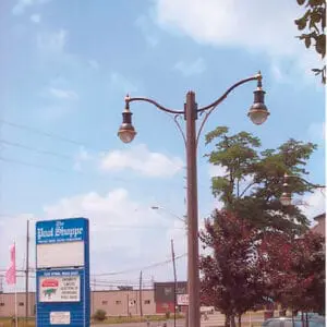K205 Marquis fixtures accompanied by mini scroll style arms on a Belmont pole.