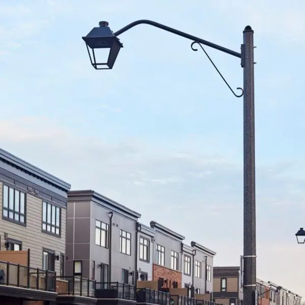 A K601D Coach Lantern fixture accompanied by Coach Lantern style arms on top of a Hexagonal Tapered pole. This project is in Grimsby, Ontario.