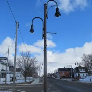 A K703 Solitaire Jr. fixture accompanied by banner arms and Bishop Crook style arms all on a Belmont pole.