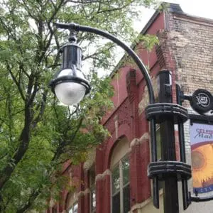A K803 Solitaire Sr. fixture accompanied by a low-rise styled arm and banner arms all on a Memphis pole. This project is in Madison, Wisconsin.