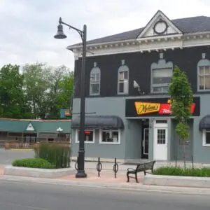 K820 Midland Sr. - Canterbury - 2 - Port Colborne, Ontario A K820 Midland Sr. fixture accompanied by banner arms and a Brookville style arm all on a Canterbury pole. This project is in Port Colborne, Ontario in front of Melina's Family Restaurant.