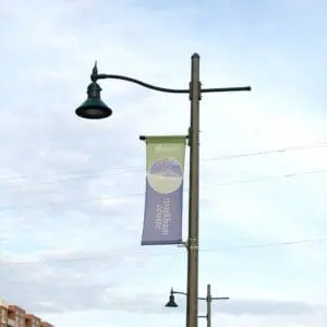 A K828 Moderne Sr. fixture accompanied by banner arms and a pipe style arm all on a Hexagonal Tapered pole.