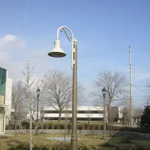 A K828 Moderne Sr. fixture accompanied by a Bishop Crook with decorative scroll arm all on a Canterbury pole.