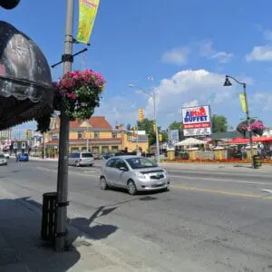 A K829 Aurora Sr. fixture accompanied by a pipe style arm, banner arms, and flowerpot holders all on top of an Octagonal Tapered pole. This project is in Clifton Hills, located in Niagara Falls, Ontario.