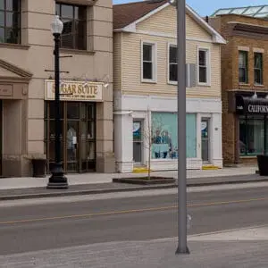 A rendering of a cobra head fixture atop a round non-tapered aluminum pole. This rendering is on a busy street in Oakville, Ontario.