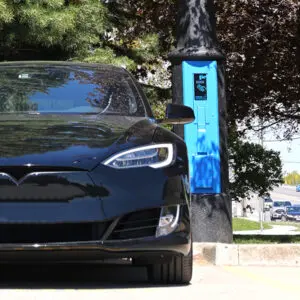 VoltLock EV Charger A black car utilizing some of the features offered by the VoltLock EV Charger pole.