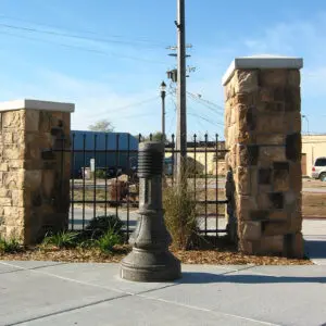 A lit Washington style bollard finished with one of our signature concrete décor colors - Midnight Lace.