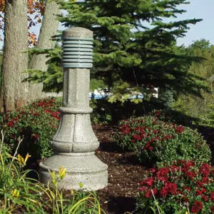 A lit Washington style bollard finished with one of our signature concrete décor colors - Pearl Gray.