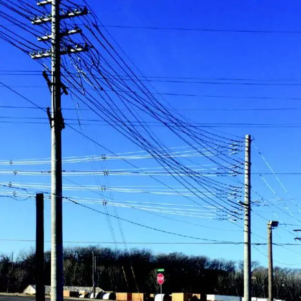 Image shows a few of StressCrete pre-stressed spun concrete poles installed to Kansas City's electrical system. With Kansas City's Board of Public Utilities continuously seeking ways to improve upon their electrical system, the BPU decided to upgrade their system with StressCrete's pre-stressed concrete poles due to their long service life, no maintenance, and lifetime warranty.