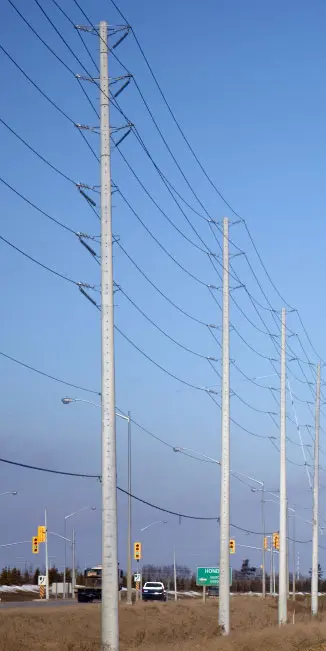 A spun concrete utility pole with a 'road crossing' application. This project is next to a busy street.