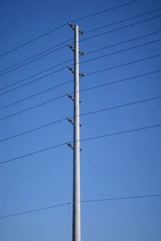 A spun concrete utility pole with a 'road crossing' application.