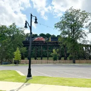 Two K804 Coronet Sr. fixtures accompanied by KA32 Pipe arms atop a fluted tapered pole with a KSB20 Cleveland Sr. split base.