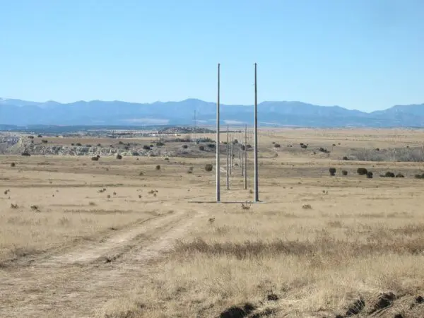 Utility Pole - Tangent Spun concrete utility poles with a 'tangent' application. This project is in a flat, remote area with mountains in the background.