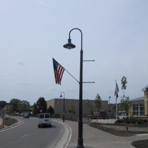 A K203 Falconridge fixture accompanied by banner arms and flag mount on a Classic pole.