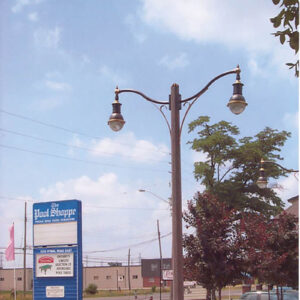 K205 Marquis fixtures accompanied by mini scroll style arms on a Belmont pole.