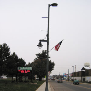 K366 Harbor Side fixture accompanied by banner arms and a flag mount all on a Kensington style pole.