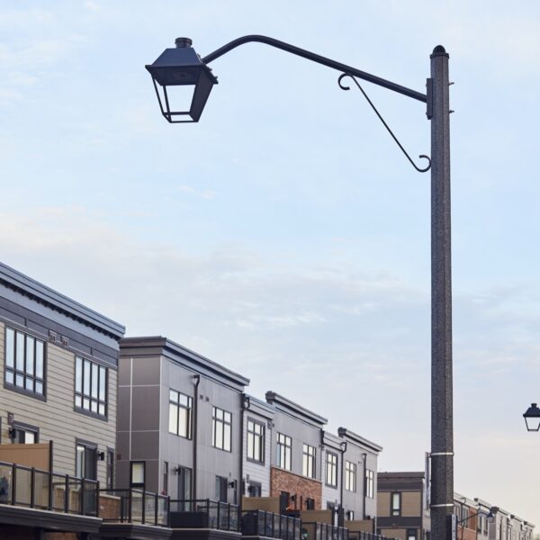 A K601D Coach Lantern fixture accompanied by Coach Lantern style arms on top of a Hexagonal Tapered pole. This project is in Grimsby, Ontario.