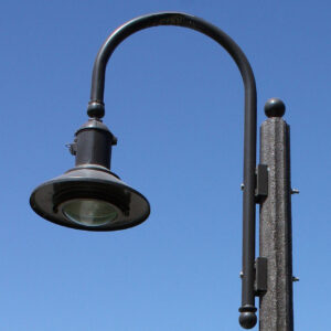 A K723 Falconridge Jr. fixture accompanied by a Bishop Crook style arm on top of a Fluted Tapered pole.