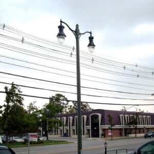 K804 Coronet Sr. fixtures accompanied by scroll style arms all on a Belmont pole.