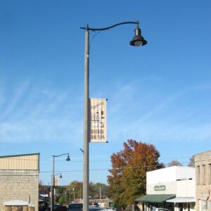 A K806 Satellite Sr. fixture accompanied by banner arms and a scroll style arm all on a Fluted Tapered pole. This project is in Houston, Texas.