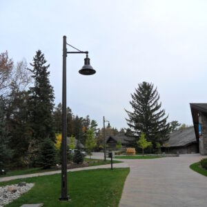 A K806 Satellite Sr. fixture accompanied by a Marina style arm all on a Round Tapered pole.