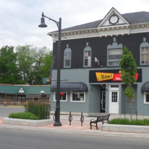 A K820 Midland Sr. fixture accompanied by banner arms and a Brookville style arm all on a Canterbury pole. This project is in Port Colborne, Ontario in front of Melina's Family Restaurant.