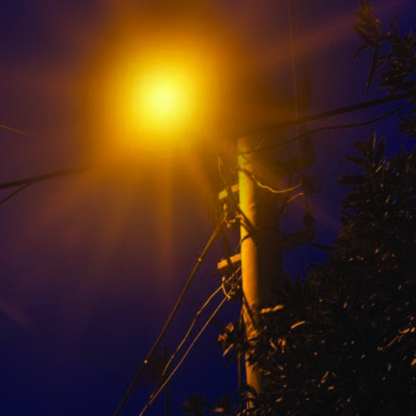 Before the city of Gresham, Oregon partnered with King Luminaire, the city experienced rising power costs to operate their streetlights. Image showcases a glare from a streetlight atop a utility pole.