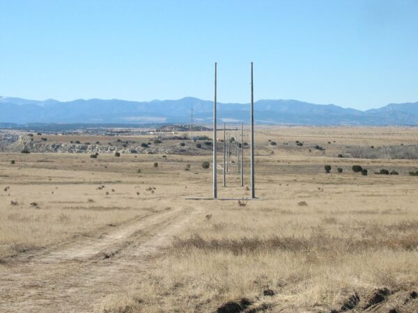 Utility Pole - Tangent Spun concrete utility poles with a 'tangent' application. This project is in a flat, remote area with mountains in the background.